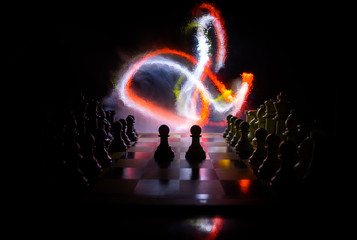 Fototapeta na wymiar Chess board game concept of business ideas and competition. Chess figures on a dark background with smoke and fog.