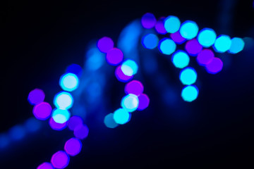 Duotone neon swirl of bokeh lights on black. Abstract background for your design