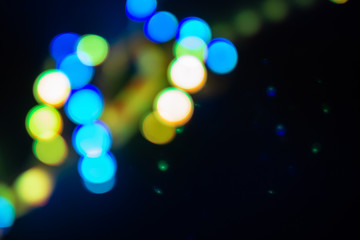 Duotone green and blue spiral of blurry neon lights. Abstract background of 80s colors