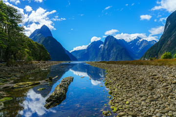 Naklejka na ściany i meble reflections of mountains in the water, milford sound, new zealand 44