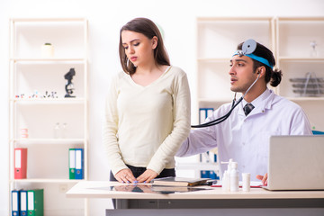 Fototapeta premium Young male doctor and female beautiful patient 