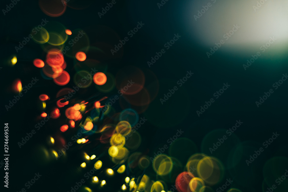 Poster Beautiful colored bokeh on a dark abstract background.