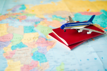 toy aircraft with two neutral passports on the world map. travel and air transportation concept, flight to africa, trip by plane, booking flights