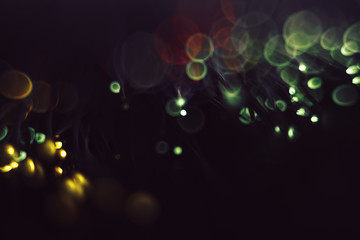 Beautiful colored bokeh on a dark abstract background.