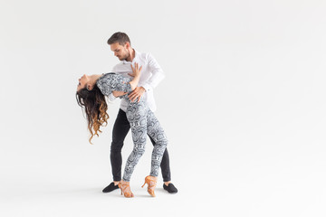 Social dance, bachata, kizomba, tango, salsa, people concept - Young couple dancing over white...
