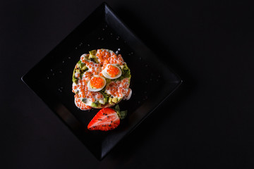 Round salad made of red fish potato and avocado