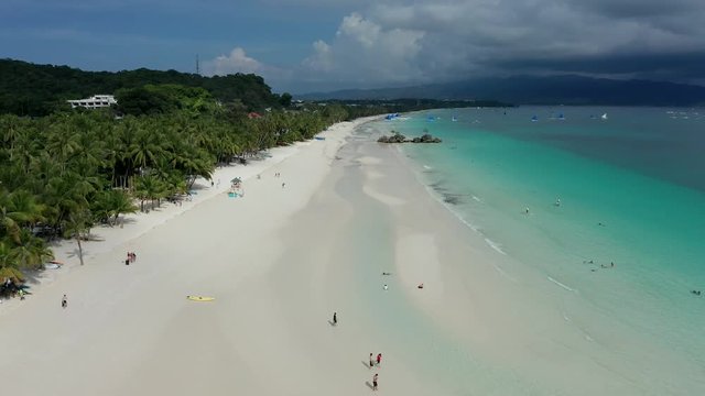 Aerial drone view of a large, beautiful tropical sandy beach (White Beach, Boracay, Philippines)