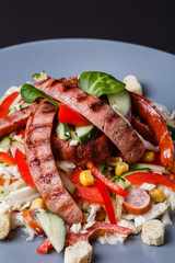 Salad with grilled sausage paprica cucumber and croutons