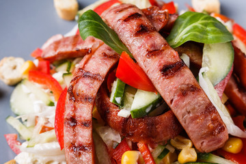 Salad with grilled sausage paprica cucumber and croutons