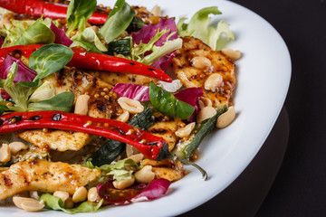 Mexican salad with hot pepper chiken fillet lettuce on plate