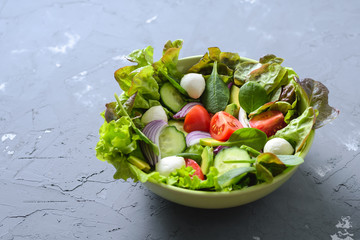 Healthy food. Vegetable salad with lettuce, tomato, avocado, cucumber, spinach and mozzarella cheese with copy space