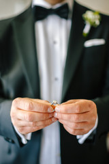 engagement ring in the hands of the groom