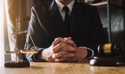 Fototapeta na wymiar justice and law concept.Male judge in a courtroom on wooden table and Counselor or Male lawyer working in office. Legal law, advice and justice concept.