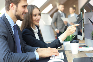 Young business people working on their desktop computers at the modern office space.