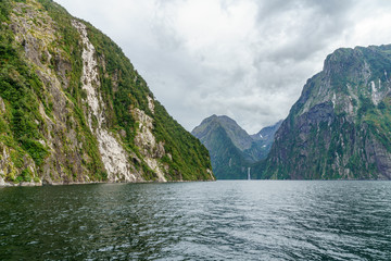 waterfall in the mountains at milford sound, fjordland, new zealand 6