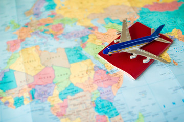 toy aircraft and neutral passport on the world map. travel and air transportation concept, flight to africa, trip by plane, booking flights