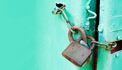 Metal door with Two old rusty padlock. Copy space. Security and protection conception