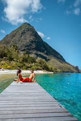 couple walking on the beach during summer vacation on a sunny day, men and woman on vacation at the tropical Island of Saint Lucia Caribbean