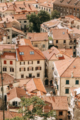 Obraz premium Tiled roofs in Montenegro and Europe. Panorama of the city of Kotor from the height of the mountain.