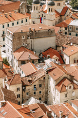 Fototapeta premium Tiled roofs in Montenegro and Europe. Panorama of the city of Kotor from the height of the mountain.