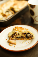 raisin roll with nuts. A piece of cake on a saucer