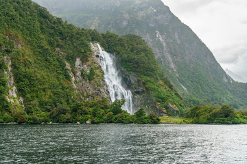 waterfall in the mountains at milford sound, fjordland, new zealand 17