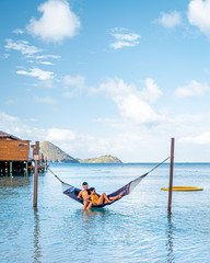 couple on luxury vatation at the tropical Island of Saint Lucia, men and woman by the beach and...