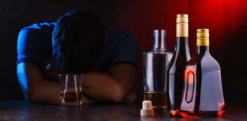 Bottles with alcoholic beverages and the figure of a drunk man