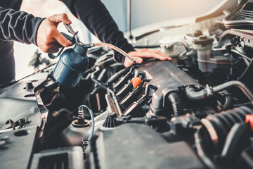 Fototapeta premium Technician Hands of car mechanic working in auto repair Service and Maintenance car