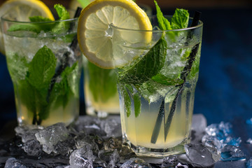 two glasses of mojito cocktail with fresh lemon peppermint and ice