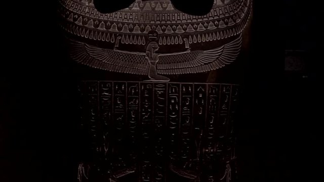 This video is a tilt shot of an ancient Egyptian pharaoh artifact on black background