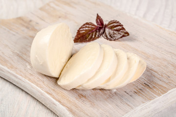 Buffalo mozzarella with purple basil. farmer homemade of mozzarella on wooden cutting board. Free space for your text