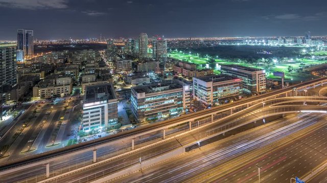 Tecom, Barsha and Greens districts aerial view from Internet city timelapse. Office and residential buildings from above. Traffic on highway and golf cource on a background