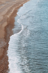 Minimalism of landscapes of Montenegro. Sandy beach and waves view from above.