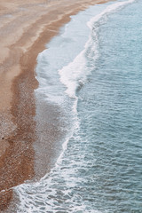 Minimalism of landscapes of Montenegro. Sandy beach and waves view from above.