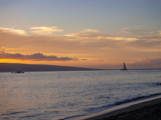 sunset on maui with a sailing boat