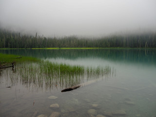 lowest of the joffrey lakes in canada with fog coming down