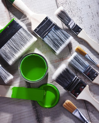 Paintbrushes of different size and paint can