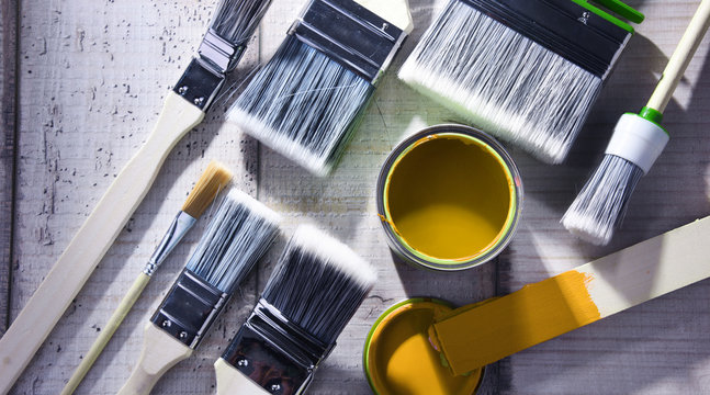 Paintbrushes of different size and paint can