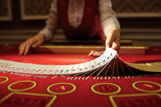 The Croupier In The Casino Does A Shuffle Of Cards