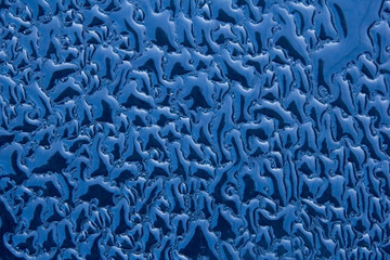 Drops of water on the wall with a new day. Closeup. Beautiful pattern for the surface background.