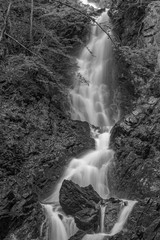 Amazing waterfall flowing from the cliffs, black&white photo