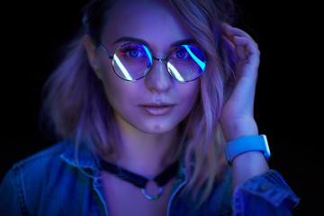 Fashion portrait of young elegant woman in sunglasses. Colored background, studio shot. 90s style