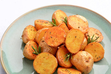 delicious baked potatoes on a rustic green plate.