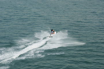 jet ski riders. man and woman ride a jet ski