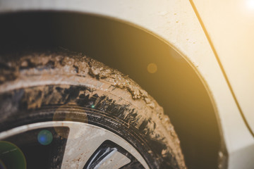 Close-up car tires are dirty on the mud.