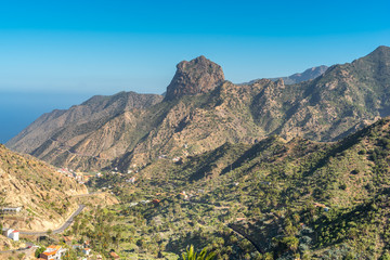 Volcanic plug in Vallehermoso what means the beautiful valley in english. View to the Roque Cano, a famous volcanic neck on the north side of La Gomera