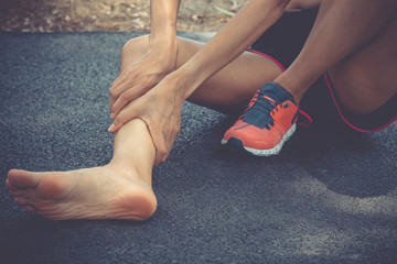 Sport woman suffering leg cramping. athlete runner training for fitness marathon hold injured shin....