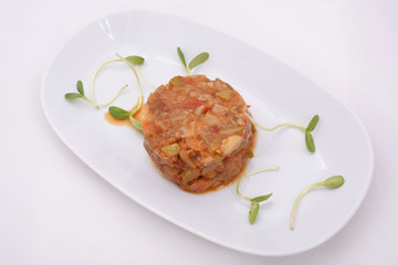 Vegetable stew served on an oval plate with greens. Spring-summer menu. Healthy Diet Food