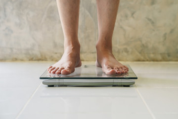 Male on weight scale on floor background, Diet concept...